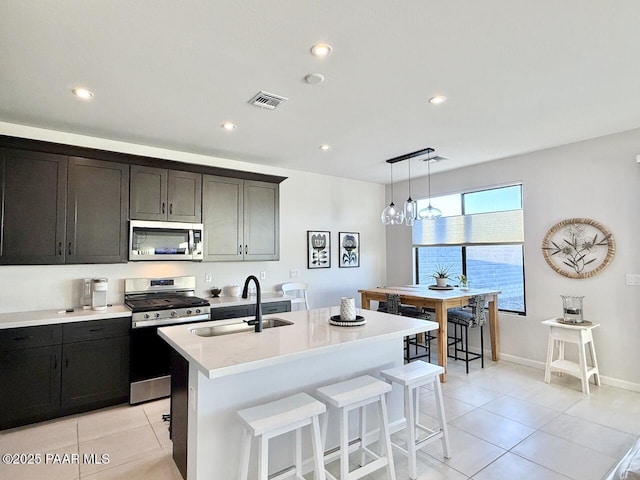 5744 E Killen Loop, Prescott Valley, AZ 86314 - kitchen featuring appliances with stainless steel finishes, a sink, light tile patterned floors, light countertops, and recessed lighting