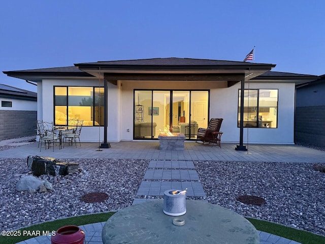 5744 E Killen Loop, Prescott Valley, AZ 86314 - back of property with a patio area, a fire pit, stucco siding, and outdoor dining space