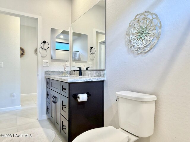 5744 E Killen Loop, Prescott Valley, AZ 86314 - half bath with toilet, vanity, baseboards, and tile patterned flooring