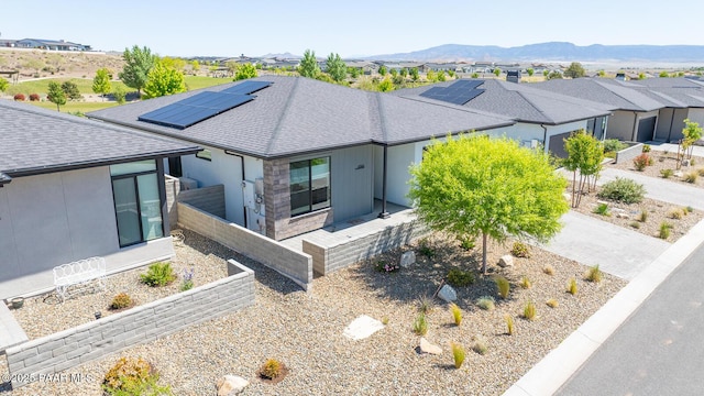 5744 E Killen Loop, Prescott Valley, AZ 86314 - view of front of home featuring a shingled roof, solar panels, a mountain view, and a residential view