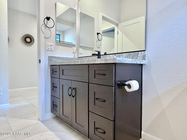 5744 E Killen Loop, Prescott Valley, AZ 86314 - bathroom featuring baseboards, vanity, tile patterned flooring, and a textured wall