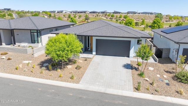 5744 E Killen Loop, Prescott Valley, AZ 86314 - view of front of house with an attached garage, decorative driveway, a residential view, stucco siding, and roof with shingles