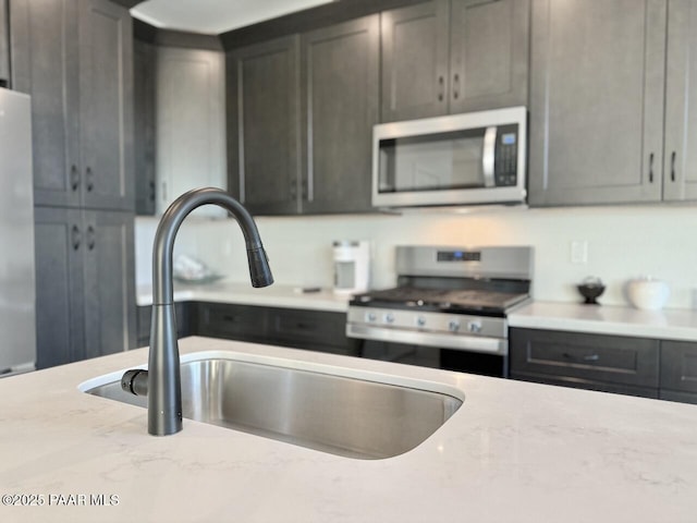 5744 E Killen Loop, Prescott Valley, AZ 86314 - kitchen featuring appliances with stainless steel finishes, a sink, and light stone countertops