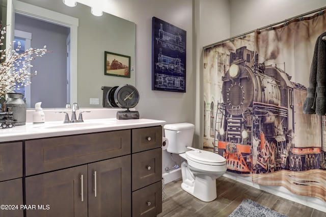 bathroom featuring hardwood / wood-style floors, vanity, and toilet