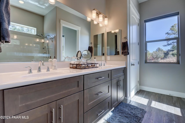 bathroom featuring wood-type flooring, vanity, and walk in shower