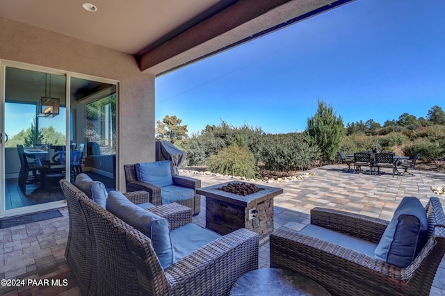 view of patio featuring an outdoor living space with a fire pit