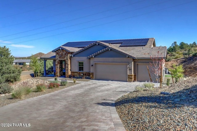 craftsman house featuring solar panels and a garage