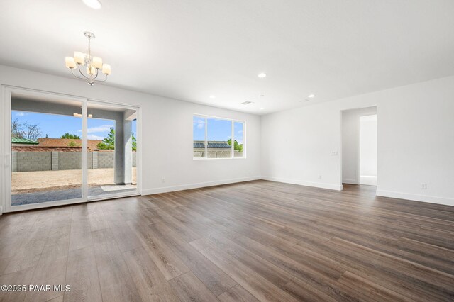 7480 E Louie Ln, Prescott Valley, AZ 86315 - unfurnished living room with baseboards, recessed lighting, wood finished floors, and a chandelier