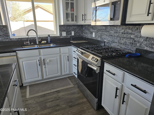 kitchen featuring dark wood-style flooring, appliances with stainless steel finishes, white cabinets, and a sink