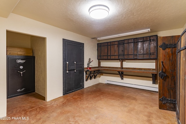 interior space with baseboard heating, finished concrete floors, and a textured ceiling