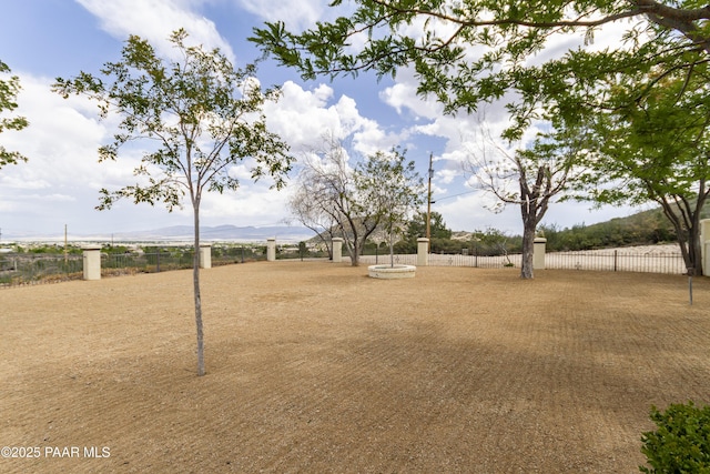 view of home's community with fence and a mountain view