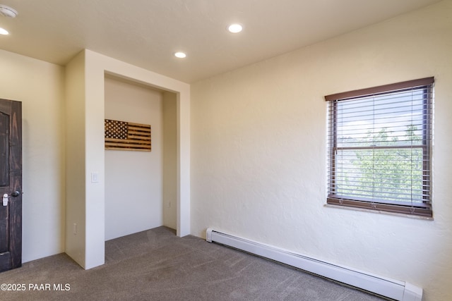 empty room featuring baseboard heating, recessed lighting, and carpet