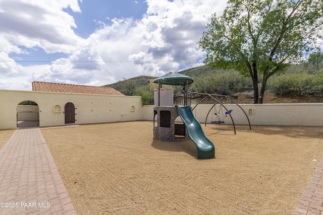 communal playground featuring a mountain view