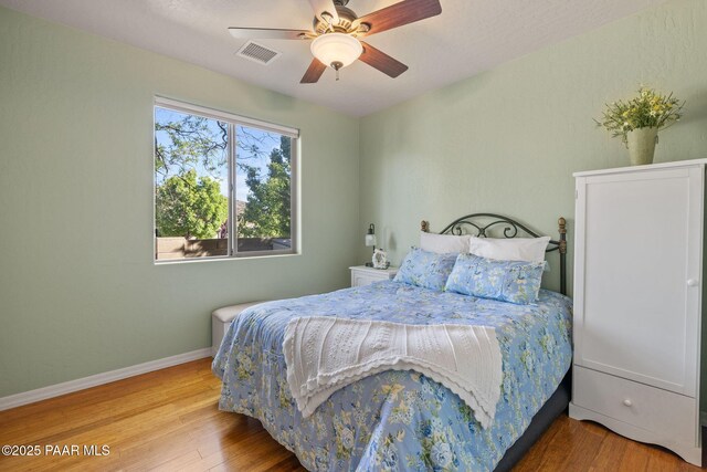 1109 N Half Hitch Rd, Prescott Valley, AZ 86314 - bedroom with wood finished floors, baseboards, and a ceiling fan