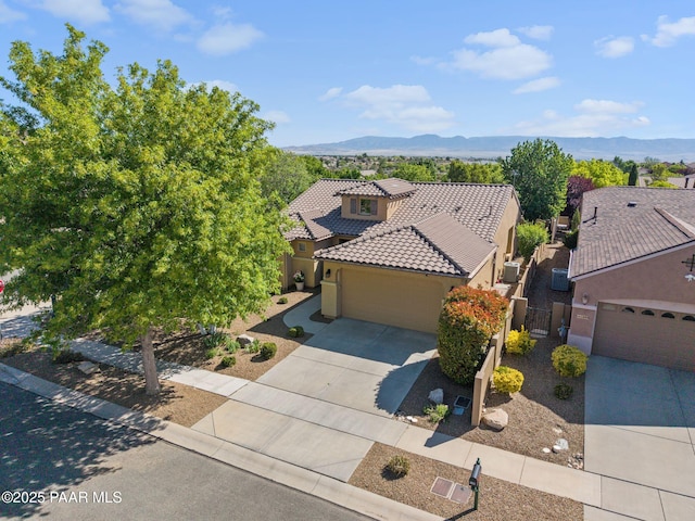 1109 N Half Hitch Rd, Prescott Valley, AZ 86314 - view of front of home featuring a tile roof, a mountain view, an attached garage, stucco siding, and driveway