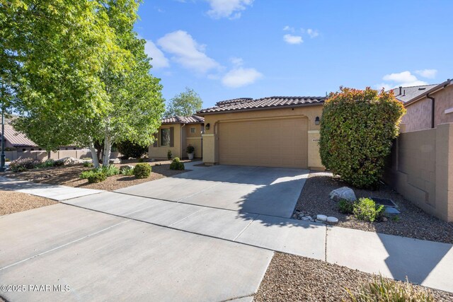 1109 N Half Hitch Rd, Prescott Valley, AZ 86314 - mediterranean / spanish house with a tile roof, stucco siding, a garage, and driveway
