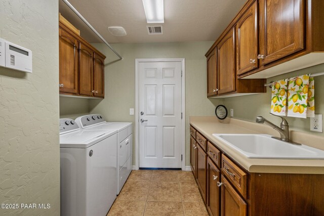 1109 N Half Hitch Rd, Prescott Valley, AZ 86314 - washroom featuring separate washer and dryer, cabinet space, and light tile patterned flooring