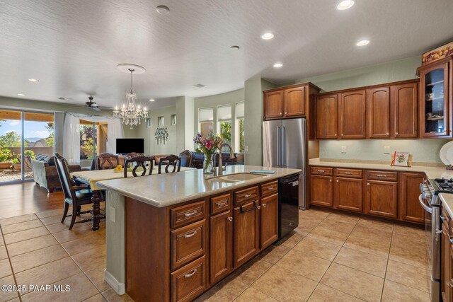 1109 N Half Hitch Rd, Prescott Valley, AZ 86314 - kitchen with a sink, appliances with stainless steel finishes, light countertops, light tile patterned floors, and a center island with sink