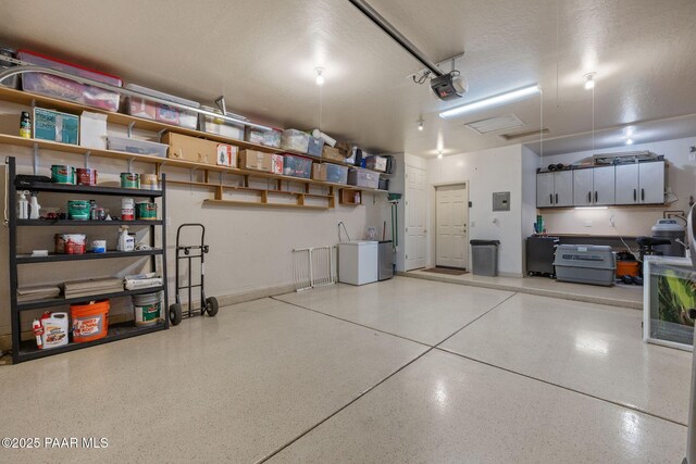 1109 N Half Hitch Rd, Prescott Valley, AZ 86314 - garage featuring electric panel, a garage door opener, and separate washer and dryer