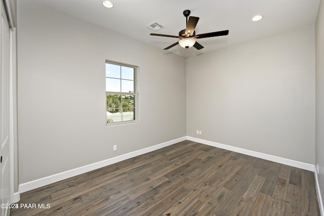 unfurnished room featuring dark wood-type flooring and ceiling fan