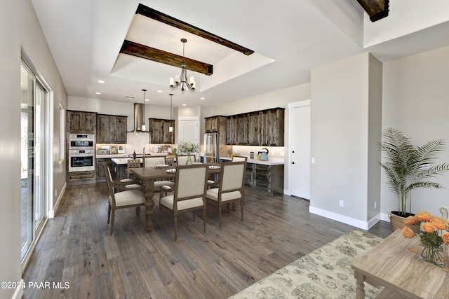 dining room with beamed ceiling, dark wood-type flooring, an inviting chandelier, and a tray ceiling