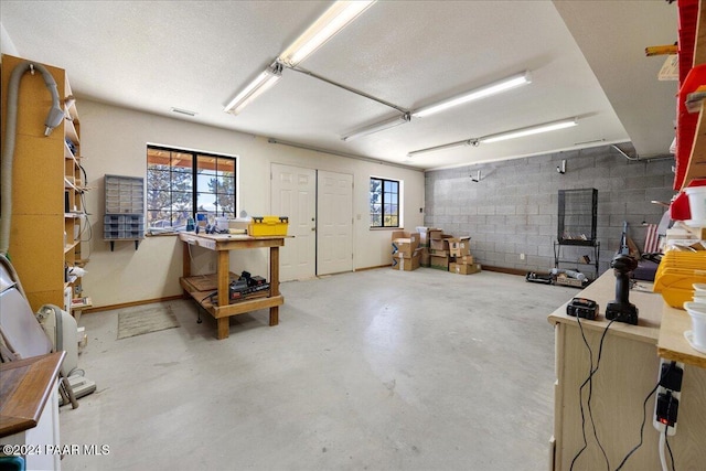 basement featuring a textured ceiling and a workshop area