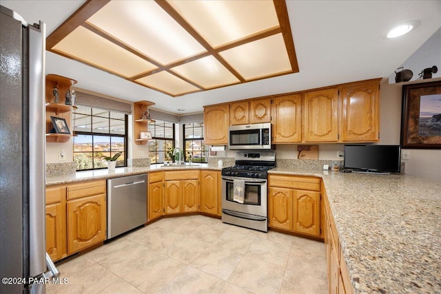 kitchen featuring light tile patterned flooring, sink, and appliances with stainless steel finishes