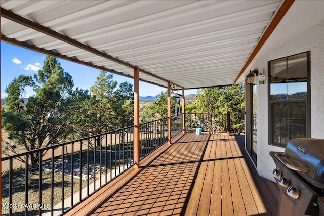 wooden terrace featuring a mountain view and area for grilling