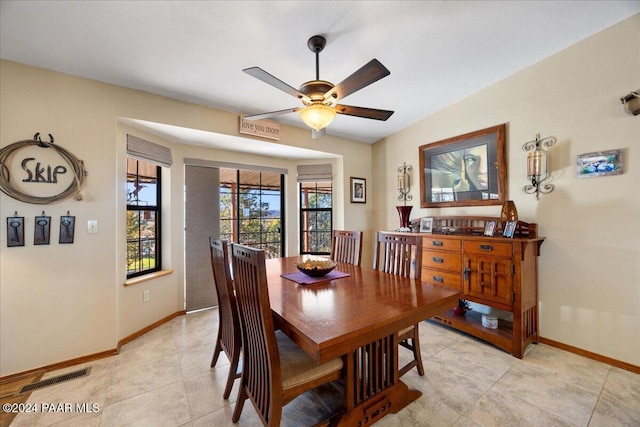 tiled dining area with ceiling fan