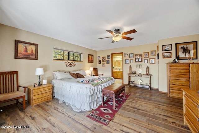 bedroom featuring ensuite bath, ceiling fan, and hardwood / wood-style floors