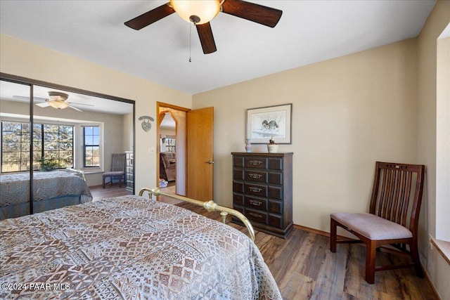 bedroom with ceiling fan, wood-type flooring, and a closet