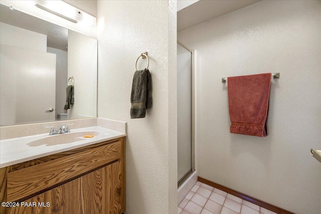 bathroom with a shower with door and vanity