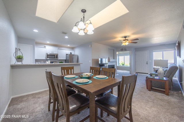 3070 Cascades Ct Unit 14C, Prescott, AZ 86301 - carpeted dining room with a chandelier, ceiling fan, a skylight, and recessed lighting