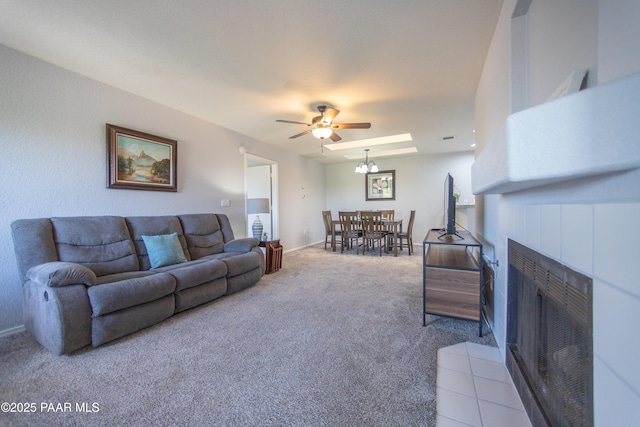 3070 Cascades Ct Unit 14C, Prescott, AZ 86301 - carpeted living area featuring a fireplace, a ceiling fan, and a chandelier