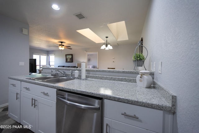 3070 Cascades Ct Unit 14C, Prescott, AZ 86301 - kitchen featuring dishwasher, a skylight, a textured wall, white cabinets, and open floor plan