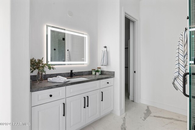 bathroom featuring vanity and a shower with shower door