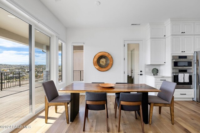 dining space with light wood-type flooring