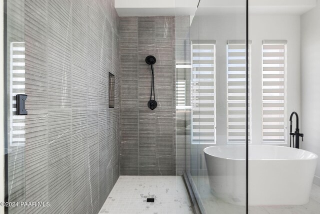 bathroom featuring tile patterned flooring and plus walk in shower