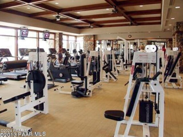 workout area featuring coffered ceiling