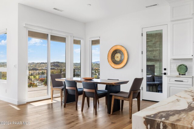 dining area featuring plenty of natural light and light hardwood / wood-style floors