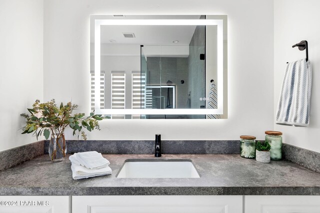 bathroom with vanity and walk in shower