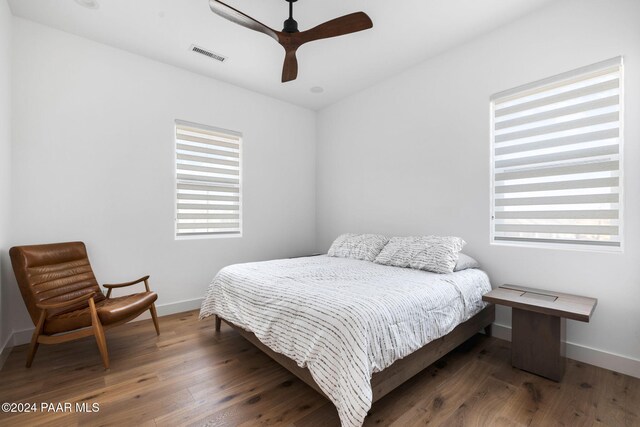 bedroom featuring dark hardwood / wood-style floors and ceiling fan