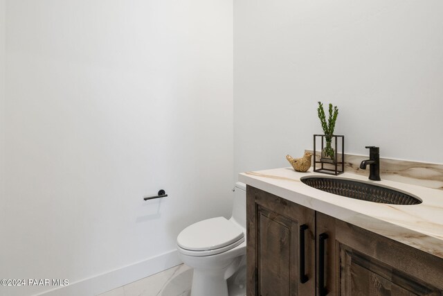 bathroom featuring tile patterned flooring, vanity, and toilet