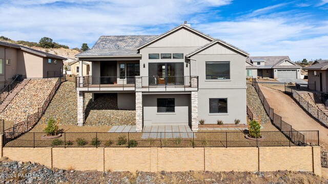 rear view of property featuring a balcony