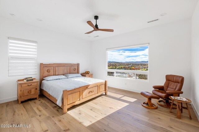 bedroom featuring light hardwood / wood-style floors and ceiling fan