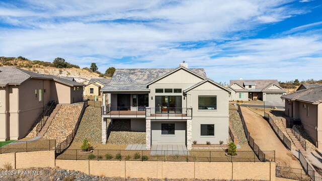 back of property with a balcony