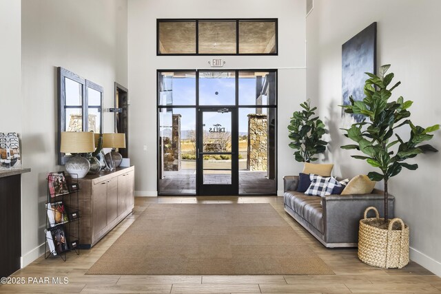 3280 Stone Cliff Ct, Prescott, AZ 86301 - doorway to outside with a towering ceiling, baseboards, and wood finished floors