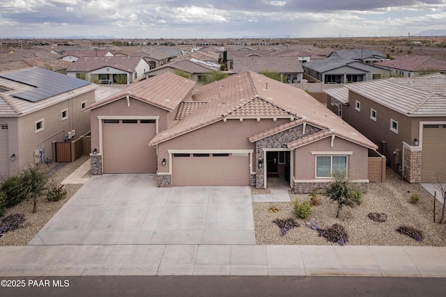 24757 N 175th Dr, Surprise, AZ 85387 - view of front of house with an attached garage, stone siding, a residential view, and concrete driveway