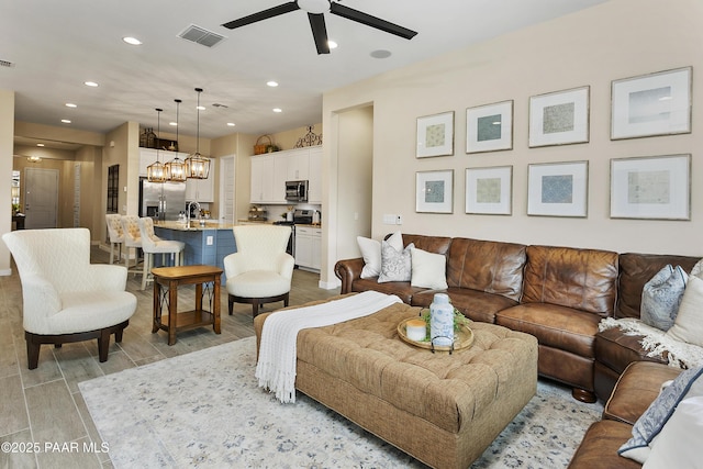 24757 N 175th Dr, Surprise, AZ 85387 - living area with ceiling fan, recessed lighting, wood tiled floors, and a chandelier