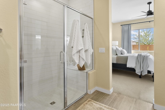 24757 N 175th Dr, Surprise, AZ 85387 - bathroom with connected bathroom, wood finish floors, a stall shower, and ceiling fan